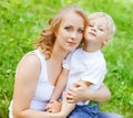 Blonde young MOther ans son playing in the park.