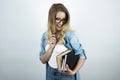 Blonde young smart woman in glasses holding books and pen white background Royalty Free Stock Photo