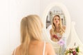 Blonde Young Woman Brush Hair, Pretty Girl Looking In Mirror Blow Wind Kisses Royalty Free Stock Photo