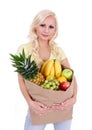 Blonde young woman with fruits in shopping bag , isolated