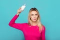 Blonde young woman a glass of milk on blue Royalty Free Stock Photo