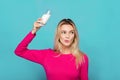 Blonde young woman a glass of milk on blue Royalty Free Stock Photo