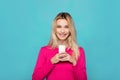 Blonde young woman a glass of milk on blue Royalty Free Stock Photo