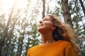 Blonde young woman looking up in the forest Royalty Free Stock Photo