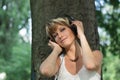 Blonde young woman in park listening to music on Royalty Free Stock Photo