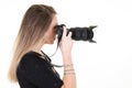 Blonde young woman profile with professional digital SLR camera on white background Royalty Free Stock Photo