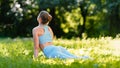 Blonde young woman yoga trainer in blue tracksuit changes upward facing dog pose exercising Royalty Free Stock Photo