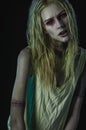 Blonde zombie woman on dark background