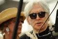 Blondie King Neptune Chris Stein speaking to the microphone at the 35th annual Mermaid Parade