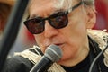 Blondie King Neptune Chris Stein speaking to the microphone at the 35th annual Mermaid Parade