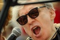 Blondie King Neptune Chris Stein speaking to the microphone at the 35th annual Mermaid Parade