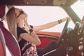 Blondie young girl at the wheel of sport car Royalty Free Stock Photo