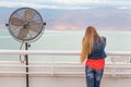 Blondie young woman posing balcony ventilator sea view.