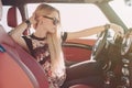 Blondie young girl at the wheel of sport car Royalty Free Stock Photo