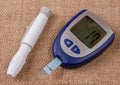 The blood glucose meter on the background of burlap