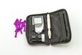 Blood glucose meter, the blood sugar value is measured on a finger pack in black case on white background. Royalty Free Stock Photo