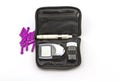 Blood glucose meter, the blood sugar value is measured on a finger pack in black case on white background. Royalty Free Stock Photo
