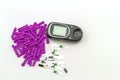 Blood glucose meter, the blood sugar value is measured on a finger pack in black case on white background. Royalty Free Stock Photo