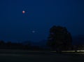 Blood moon eclipse during summer 2018 with planet Mars above fields in the night sky, Bavaria Royalty Free Stock Photo