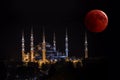 Blood moon and historical Islamic temple Blue Mosque at night