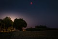 Blood Moon 2018 - The total lunar eclipse and the planet Mars on July 27, 2018. Night landscape with trees and backlight. Royalty Free Stock Photo