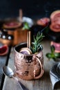 Blood orange cocktail in a copper mug with red orange and lemon, cinnamon and mint on a wooden background. Oranges Wicker Basket