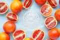 Blood oranges and glass juicer on blue background. Top view