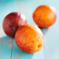 Blood oranges on rustic painted table