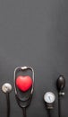 Medical stethoscope and sphygmomanometer on black background, top view Royalty Free Stock Photo