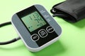 Blood pressure measuring device on green background, closeup Royalty Free Stock Photo
