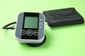 Blood pressure measuring device on green background, closeup Royalty Free Stock Photo