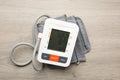 Blood pressure measuring device on wooden table, top view Royalty Free Stock Photo