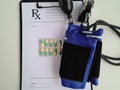 Blood pressure monitor and prescription pills on table closeup