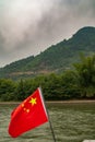 Blood red Chinese flag and mountain scenery along Li River in Guilin, China Royalty Free Stock Photo