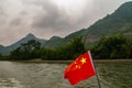 Blood red Chinese flag and mountains scenery along Li River in Guilin, China Royalty Free Stock Photo