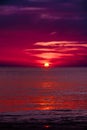 Blood red and dark purple sunset of sun sets over horizon Adaman Sea