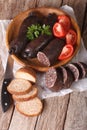 Blood sausages and vegetables on a table close-up. Vertical Royalty Free Stock Photo