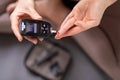 Blood sugar testing at home. Woman checking blood sugar level by glucometer and test stripe at home. Diabetic checking Royalty Free Stock Photo