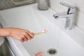 Blood on toothbrush on background of sink. Selective focus on the toothbrush Royalty Free Stock Photo