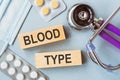 BLOOD TYPE written on wooden cubes on medical background