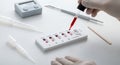 Blood Typing Test with Dropper on White Surface in Laboratory Setting with Sterile Gloves and Various Medical Tools Royalty Free Stock Photo