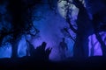 bloodthirsty zombies attacking. hungry zombies in the woods. Silhouettes of scary zombies walking in the forest at night Royalty Free Stock Photo