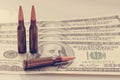 The bloody business of war. Bullets on dollar bills as symbol of