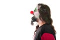 Bloody clown in a face profile looking at a copyspace, isolated