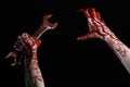 Bloody hand holding a big wrench, bloody wrench, big key, bloody theme, halloween theme, crazy mechanic, black background Royalty Free Stock Photo