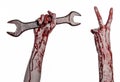 Bloody hand holding a big wrench, bloody wrench, big key, bloody theme, halloween theme, crazy mechanic, white background Royalty Free Stock Photo