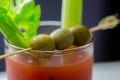 Bloody Mary cocktail prepared with pure vodka, tomato juice and hot pepper sauce, drink decorated with three olives and celery Royalty Free Stock Photo