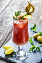 Bloody Mary cocktails with tomato juice and spicy vodka, decorated with pickle and olive garnish Royalty Free Stock Photo