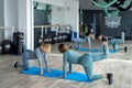 Bloody two young female trainers train in the hall performing exercises for health.