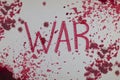 Bloody word War with splatters, droplets, stains on paper background